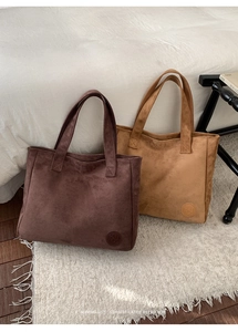 Detailed texture of suede tote bags in dark coffee and light brown colors