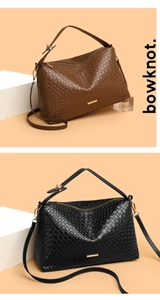 Detailed view of woven leather handbags in brown and black with gold metal hardware accents