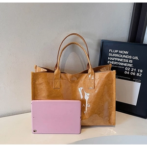 Brown semi-transparent tote bag with AG print showing large capacity for a tablet