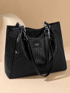 Detail of woven black PU leather tote featuring silver chain strap and logo patch