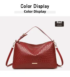 Detail view of red woven hobo bag showing intricate checkerboard texture and gold metal accents