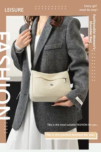 Detail of cream-colored waterproof nylon crossbody bag with front zipper pocket and strap