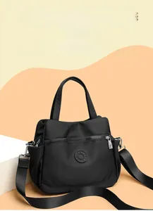 Detail of waterproof nylon crossbody bag with zipper pocket and detachable strap