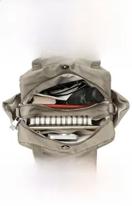 Detail of multi-layer khaki nylon shoulder bag interior showing large storage capacity