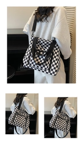 Detail of checkered tote bag with adjustable shoulder strap and silver zipper pocket