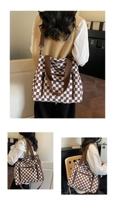 Detail of checkered tote bag with brown straps and spacious interior for daily commute