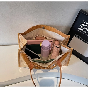Spacious interior of the brown Tyvek tote bag showing organized daily essentials