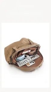 Internal view of khaki nylon backpack showing large storage and 9.7 inch tablet compartment