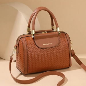 Caramel brown woven handbag for women with top handle and crossbody strap design