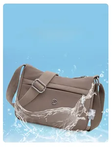 Close-up of waterproof coffee nylon fabric with splash effect on crossbody shoulder bag