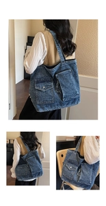 Detailed view of the dark blue washed denim tote bag with functional exterior cargo pockets