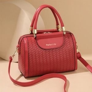 Elegant red woven leather bucket bag with top handles and adjustable shoulder strap