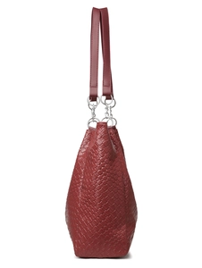 Close-up of woven texture on burgundy faux leather tote bag with silver metal ring