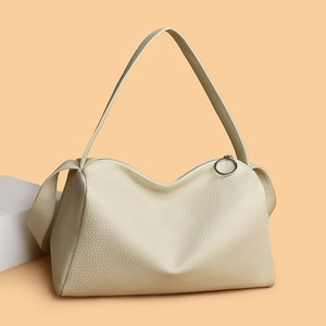 Minimalist beige pebble leather tote bag with unique wavy top and silver ring zipper