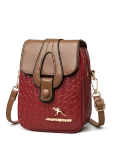 Detail of red woven mini crossbody bag with brown flap and gold kangaroo metal logo