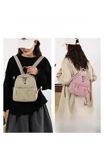 Detailed view of compact nylon backpacks in khaki and pink with stylish pleated front pockets