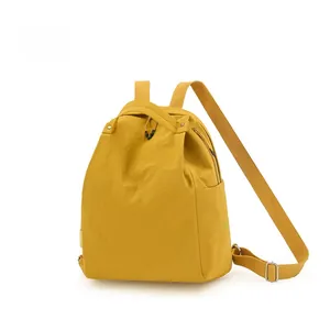 Detail of water-resistant yellow nylon backpack with Ruishi logo and adjustable straps