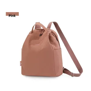 Side view detail of a dusty pink waterproof nylon backpack with adjustable straps