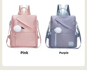 Pink and purple nylon backpacks featuring side zippers and white fluffy pom pom charms