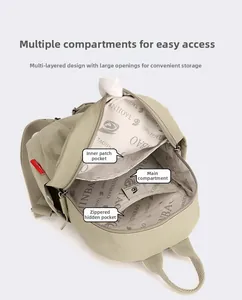 Detail view of the beige oxford canvas backpack featuring multi-layer inner pockets and lining