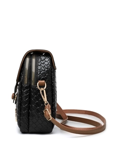 Close-up of dual gold zippers and woven leather texture on a stylish crossbody bag