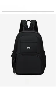 Close-up of black nylon backpack featuring dual front zipper pockets and metal logo detail