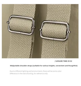 Detail of adjustable khaki canvas shoulder strap with silver metal buckle on backpack