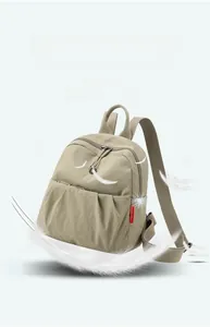 Detailed view of lightweight nylon backpack with pleated pockets and feather elements