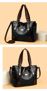Détail d'un sac cabas noir en cuir grainé avec anses brunes et finitions métalliques