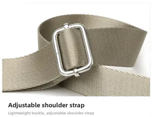 Close-up of adjustable khaki nylon shoulder strap with a silver metal buckle detail