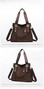 Deep brown tote bag with multiple zipper pockets and adjustable shoulder strap detail