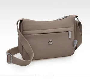 Side view of khaki nylon crossbody bag featuring waterproof material and multi-layer zippers