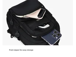 Detail of multi-layered front zipper pockets storing phone and power bank in black travel bag