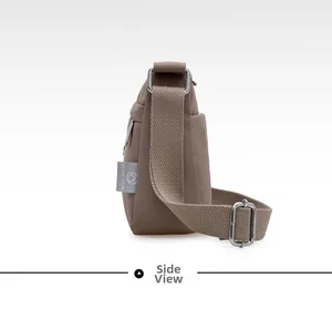 Side view of lightweight nylon crossbody bag featuring adjustable strap and logo label