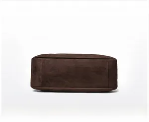 Detailed view of the reinforced bottom stitching on a large brown suede tote bag