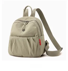Detailed side view of light green pleated nylon backpack with adjustable shoulder straps