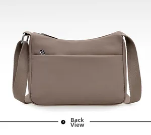 Rear view of lightweight nylon crossbody bag showing the functional back zipper pocket