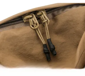 Detail of durable khaki nylon backpack featuring smooth dual zippers with braided pull cords