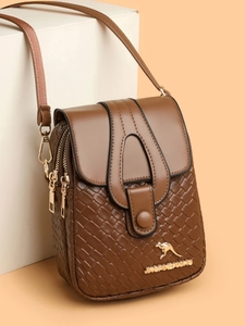 Detail of brown PU leather crossbody bag with woven texture and gold kangaroo metal logo