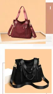 Detail of large suede tote bags with functional zippers in burgundy and black colors
