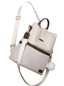Zaino da donna in tessuto Oxford beige e marrone con ciondolo a pompon e design antifurto