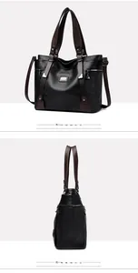 Détail du sac cabas noir avec logo métallique et poches latérales à fermeture éclair