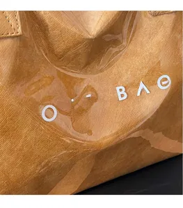 Detail shot of the transparent PVC outer layer and brown wrinkled inner tote bag