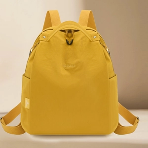 Bright yellow waterproof nylon backpack for women featuring a minimalist trendy design