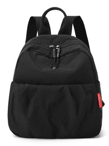 Minimalist black oxford canvas backpack with pleated design and red decorative tag