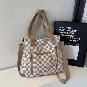 Checkered canvas tote bag with triple zipper pockets and adjustable shoulder strap