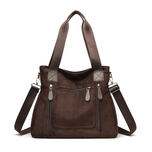 Large brown suede tote bag with multi-zipper pockets and adjustable shoulder strap