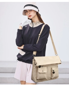 Detail of light beige folding tote bag with envelope flap and double pockets on a model