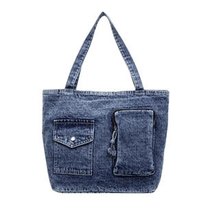 Classic blue washed denim tote bag featuring dual front pockets and vintage workwear style