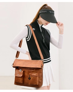 Detail of a brown vintage tote bag featuring multiple front pockets and matte texture